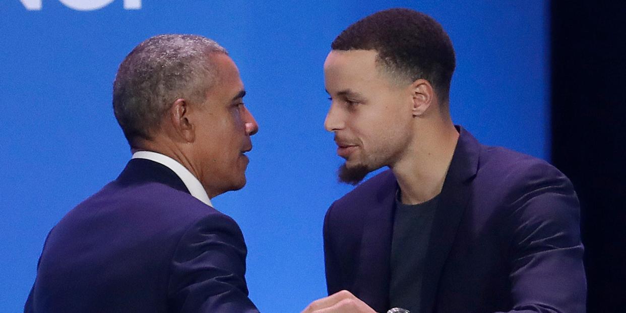 Barack Obama and Stephen Curry lean in to hug at an event in 2019.