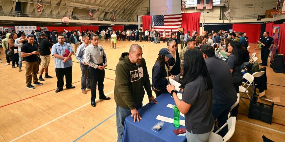 People are in a line at a career fair