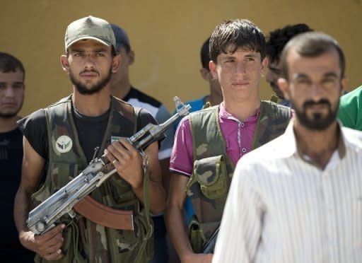 Volunteers for the Amr Ibn al-Aass rebel brigade take part in training on the outskirts of Azaz, in northern Syria. Syrian rebels seized a crossing on the Turkish border Wednesday even as they quit a swathe of south Damascus that activists said had been reduced to a disaster area by weeks of heavy fighting