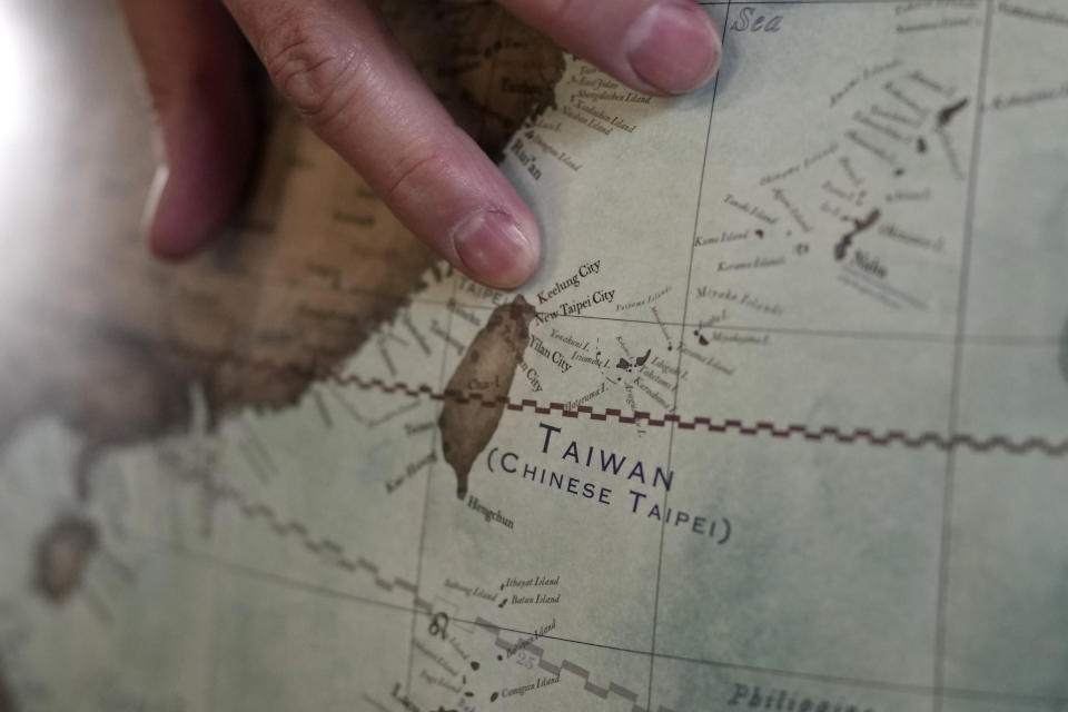 Peter Bellerby, the founder of Bellerby & Co. Globemakers, points to a map of Taiwan at a studio in London, Tuesday, Feb. 27, 2024. Globes in the age of Google Earth capture the imagination and serve as snapshots of how the owners see the world and their place in it. Peter Bellerby made his first globe for his father, after he could not find one accurate or attractive enough. In 2008, he founded Bellerby & Co. Globemakers in London. His team of dozens of artists and cartographers has made thousands of bespoke globes up to 50 inches in diameter. The most ornate can cost six figures. (AP Photo/Kin Cheung)