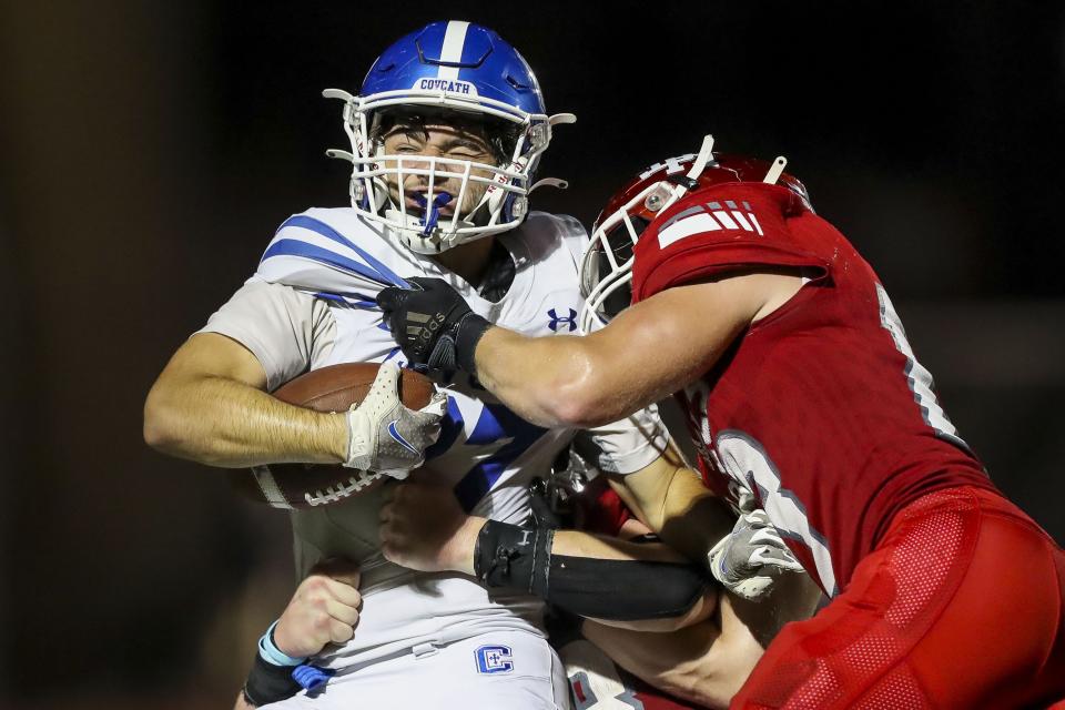 Covington Catholic wide receiver Casey Bir (27) runs with the ball against Dixie Heights linebacker Brach Rice (8) in the second half at Dixie Heights High School Sept. 9, 2022.