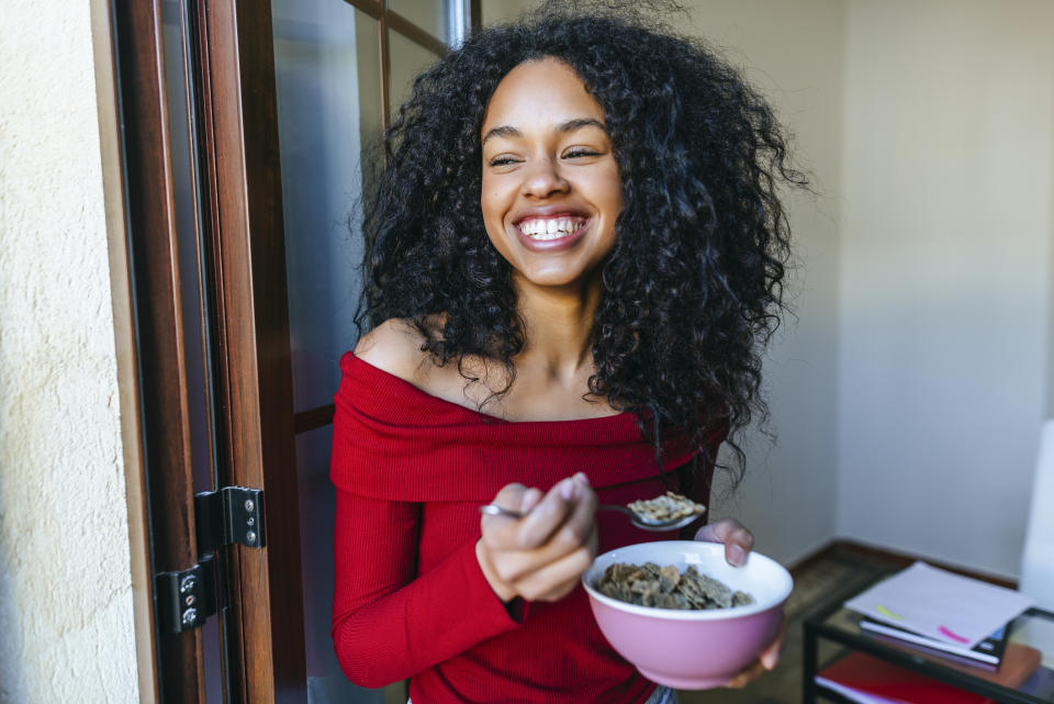 A woman eating and smiling