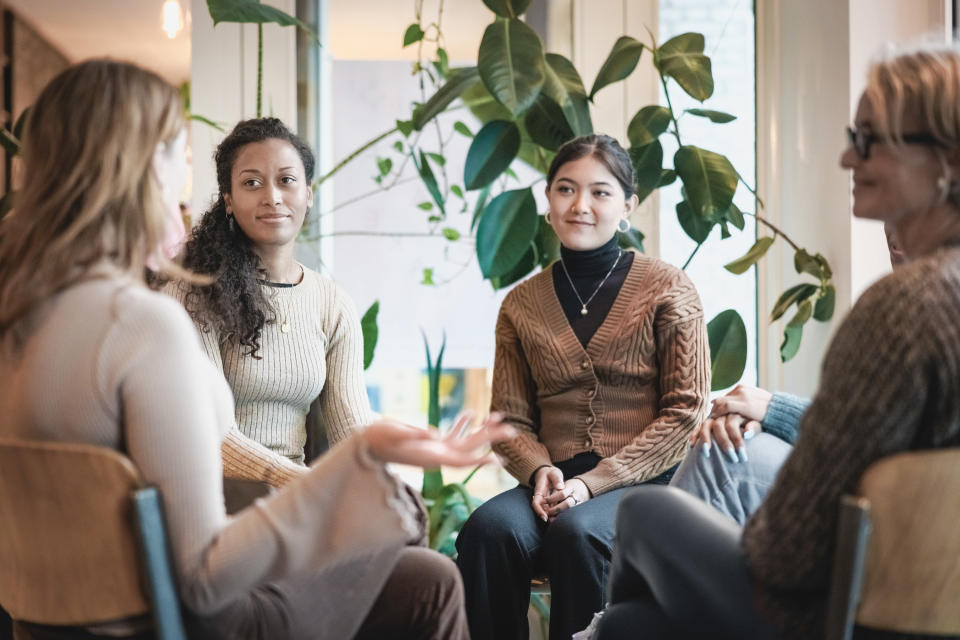 women in an office sitting in a circle