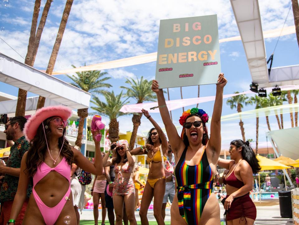 A festivalgoer holds up a Big Disco Energy sign during weekend two of Splash House at The Saguaro in Palm Springs, Calif., Saturday, Aug. 13, 2022. 