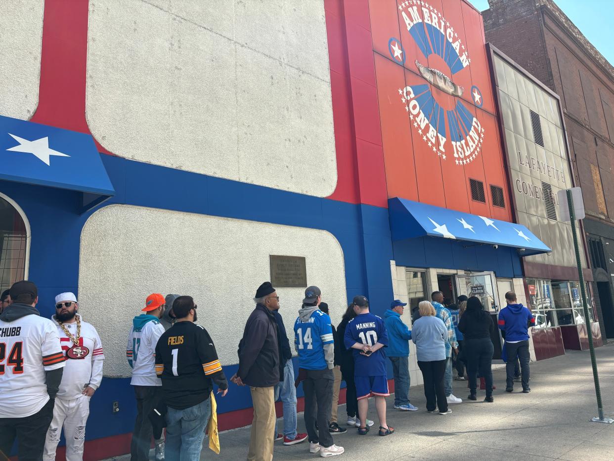 A line forms outside of American Coney Island on the first day of the 2024 NFL draft.