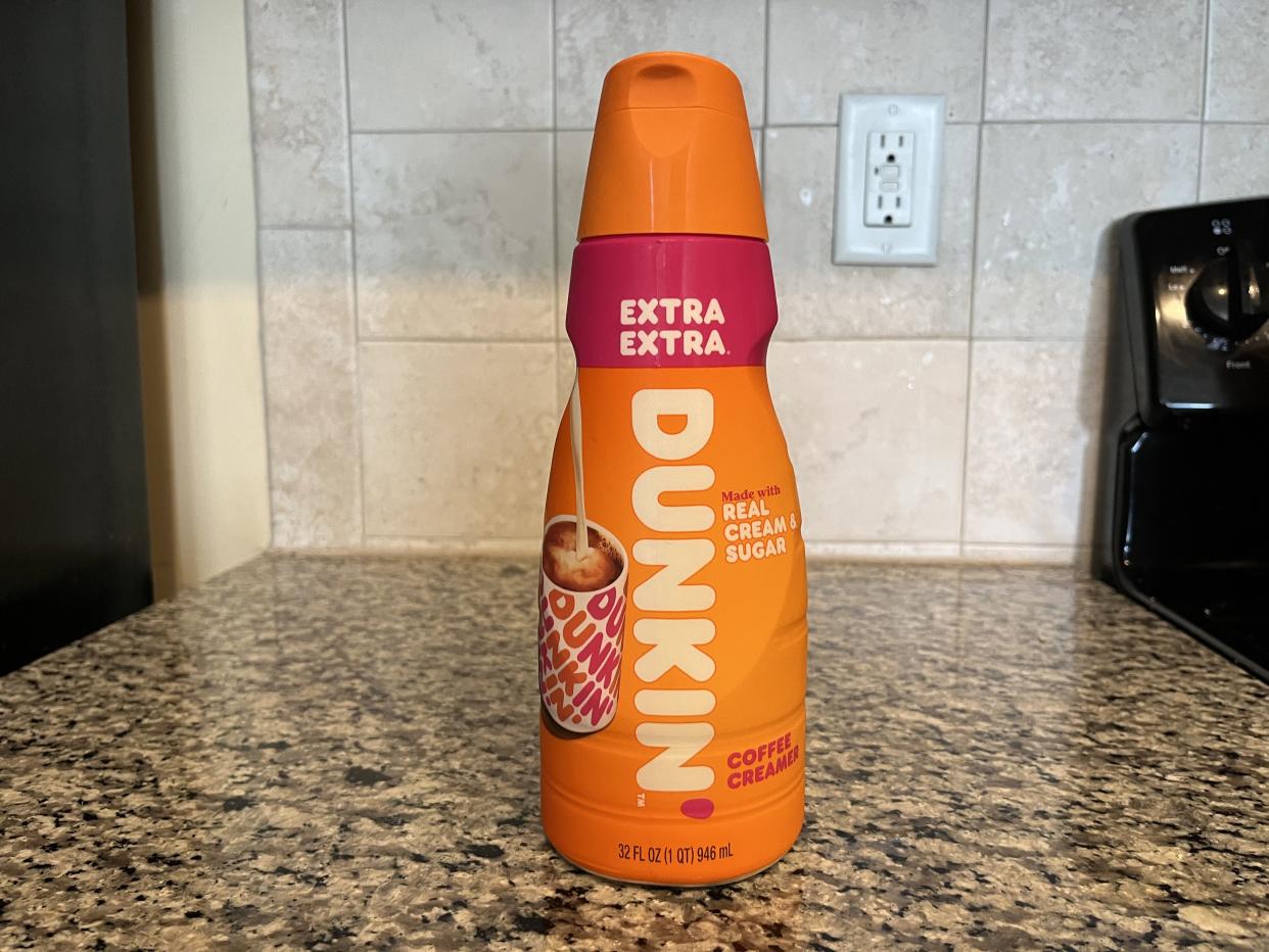a bottle of dunkin donuts coffee creamer with real milk and sugar