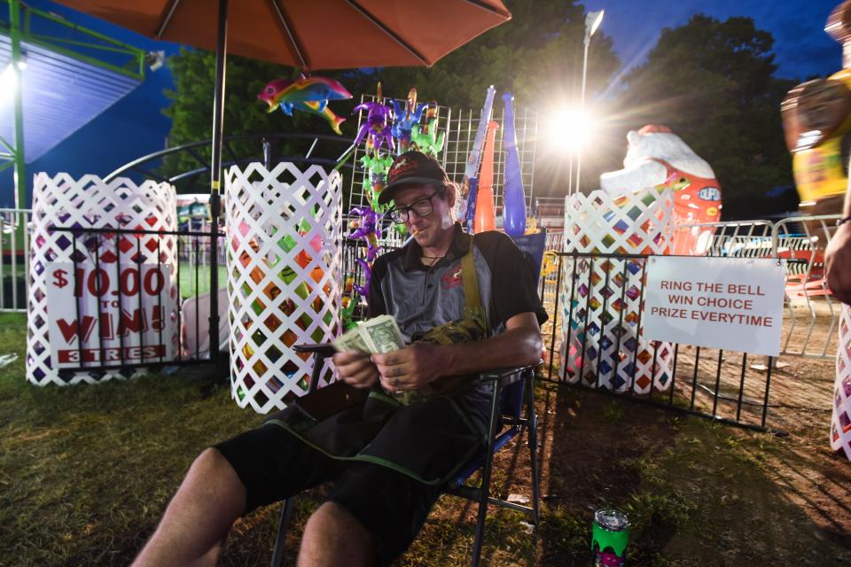 "A common misconception is that we're uneducated. In reality we're highly educated, not just in book smarts but social smarts," carnival worker Christian Desirey, 33, of Bangor, Maine says during a break at the Eaton County Fair in Charlotte.