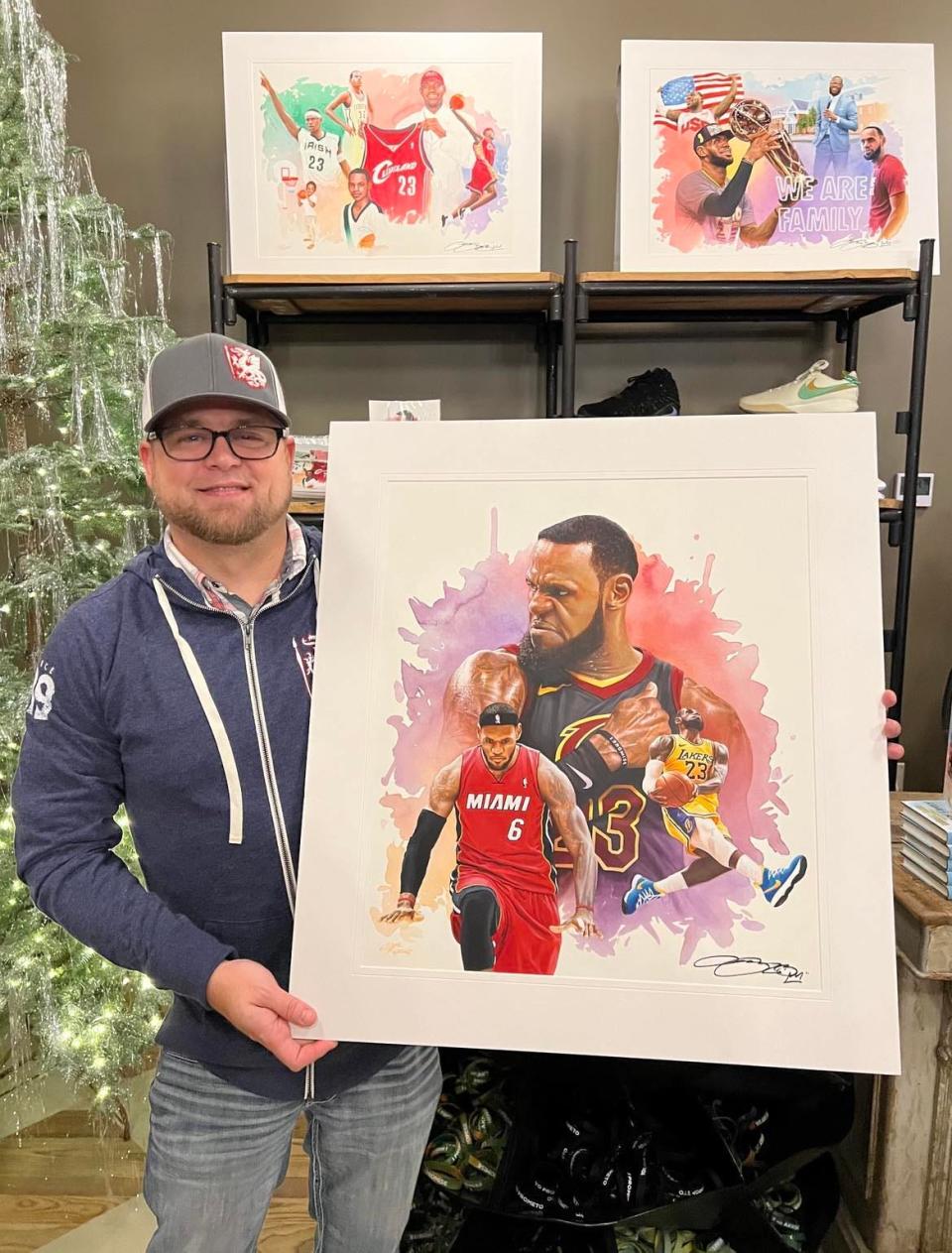 Stark County artist Dirk Rozich displays a painting he created of LeBron James that was digitally enlarged into a mural at the LeBron James' Home Court museum in Akron.