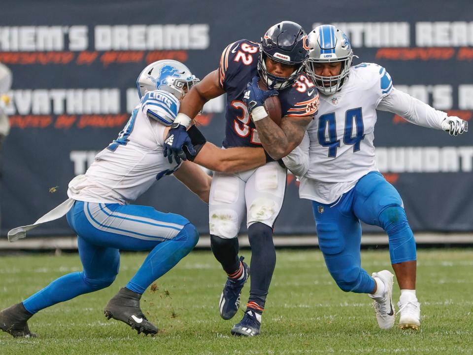 David Montgomery fights through a tackle against the Detroit Lions.