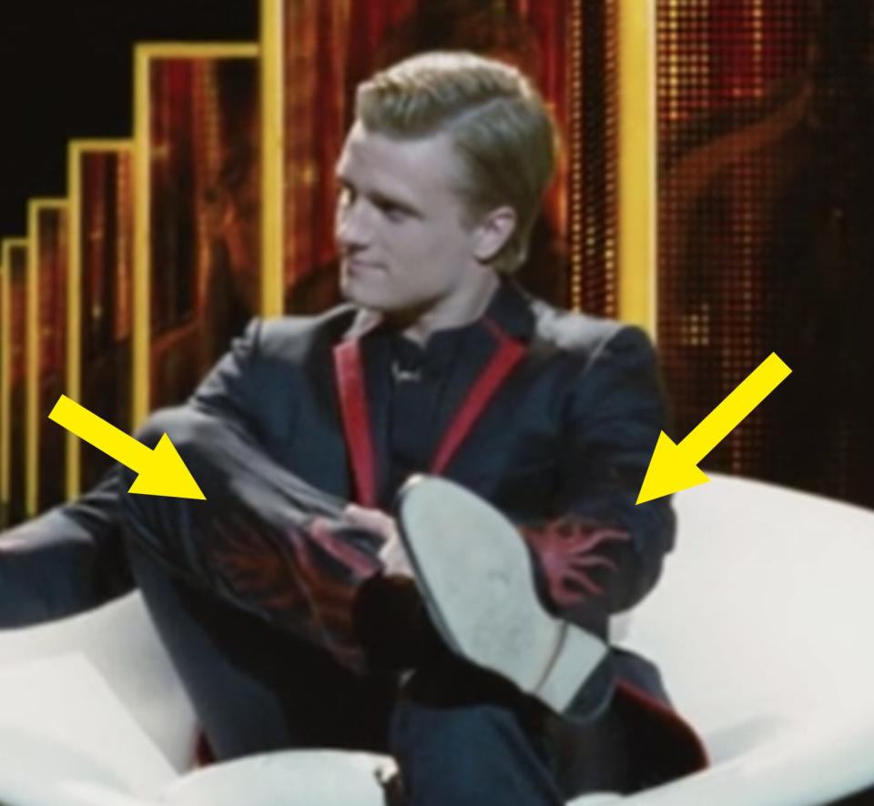 flame appliques on peeta's suit