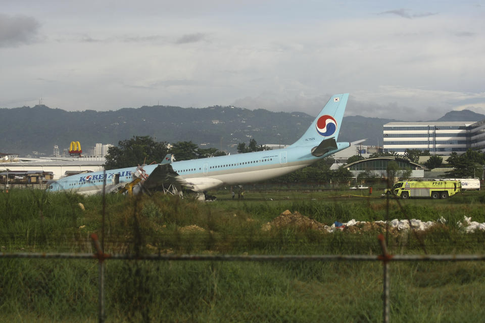 A damaged Korean Air plane lies after it overshot the runway at the Mactan-Cebu International Airport in Cebu, central Philippines early Monday Oct. 24, 2022. The Korean Air plane overshot the runway while landing in bad weather in the central Philippines late Sunday, but authorities said all 173 people on board were safe. (AP Photo/Juan Carlo De Vela)