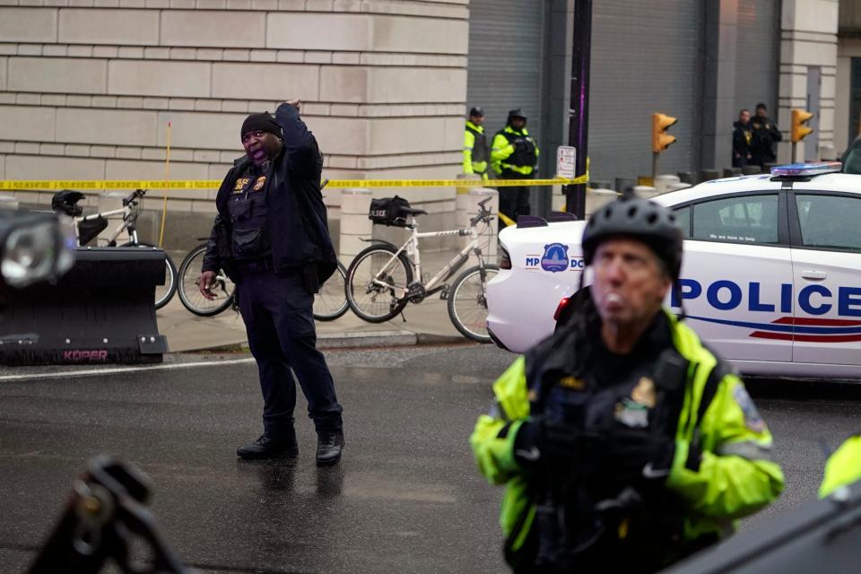 DC police stand outside as Former President Donald Trump arrives at the U.S. Circuit Court of Appeals for the District of Columbia on Jan. 9, 2024, to appeal on whether he is immune from prosecution on charges that he illegally tried to overturn the 2020 election in Washington.