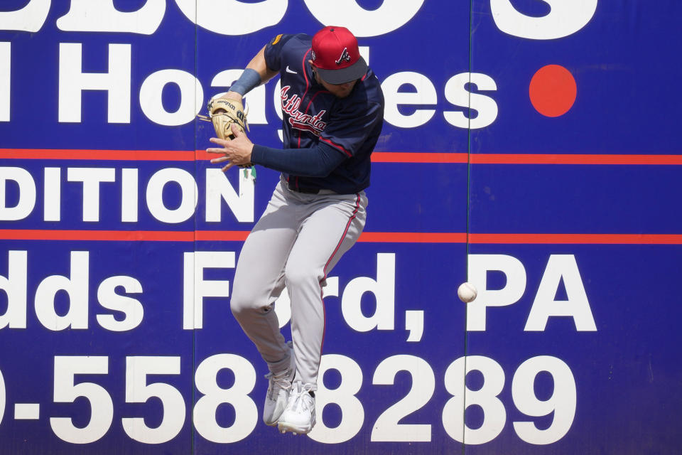 Atlanta Braves left fielder Jarred Kelenic fields a double by Philadelphia Phillies second baseman Whit Merrifield off the wall during the fourth inning of a spring training baseball game Wednesday, Feb. 28, 2024, in Clearwater, Fla. (AP Photo/Charlie Neibergall)