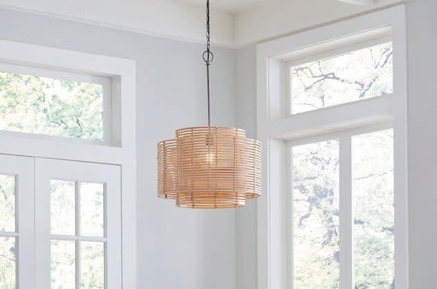 the rattan chandelier hanging in a room