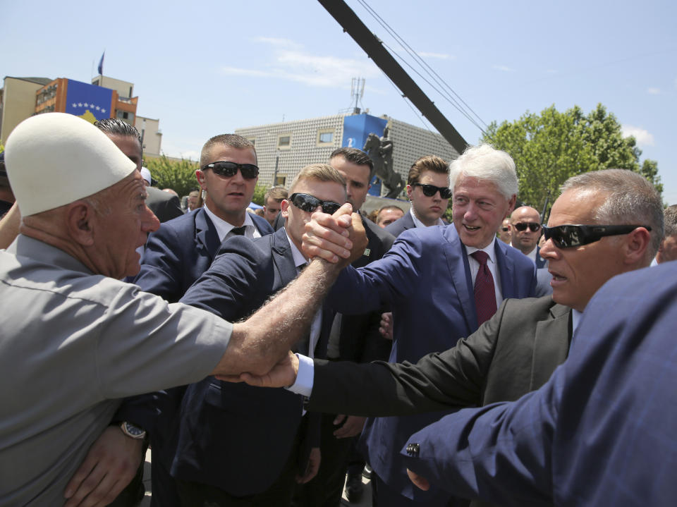 Former U.S. President Bill Clinton, center right, shakes hands with an elderly ethnic Albanian wears his traditional cap during anniversary celebrations in the capital Pristina, Kosovo, Wednesday, June 12, 2019. It’s exactly 20 years since NATO forces set foot in the former Yugoslav province, after an allied bombing campaign ended Serbia’s bloody crackdown on an insurrection by the majority ethnic Albanian population in Kosovo _ revered by Serbs as their historic and religious heartland. (AP Photo/Visar Kryeziu)