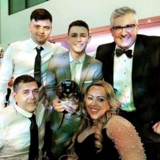 Phil Foden (with trophy) alongside his long-term friend and adviser Richard Green (right) - PHIL FODEN: INSTAGRAM
