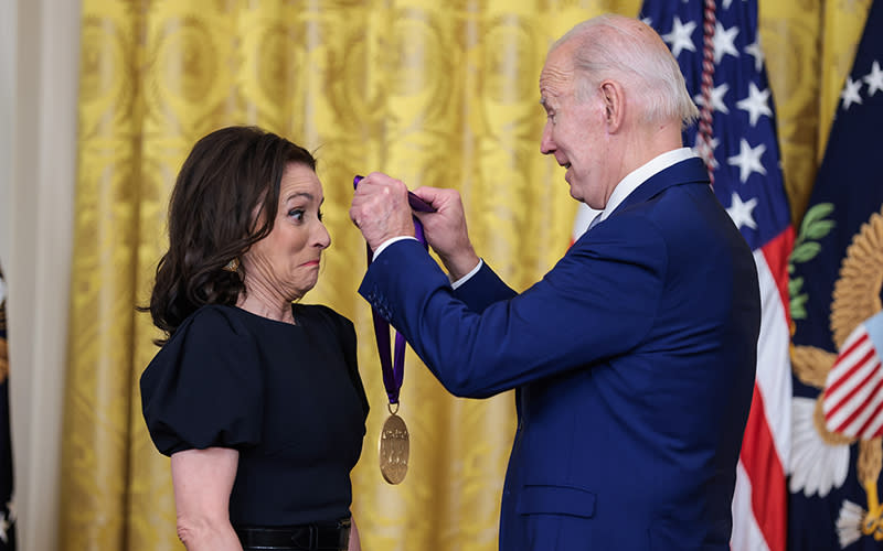 Julia Louis-Dreyfus is honored on stage by President Biden during an event