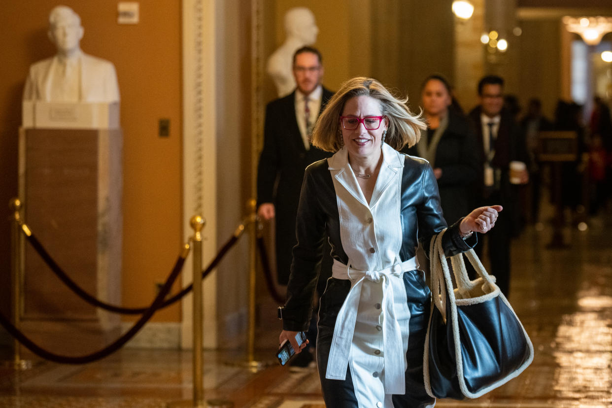Sen. Kyrsten Sinema walks through the Capitol.