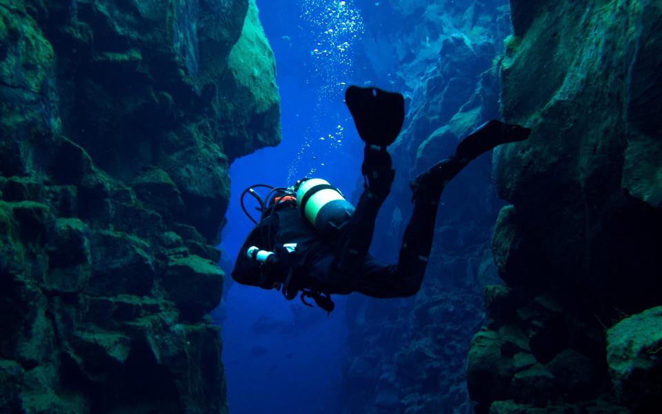 Scuba diving at Silfra, Iceland at the Continental divide - iStock