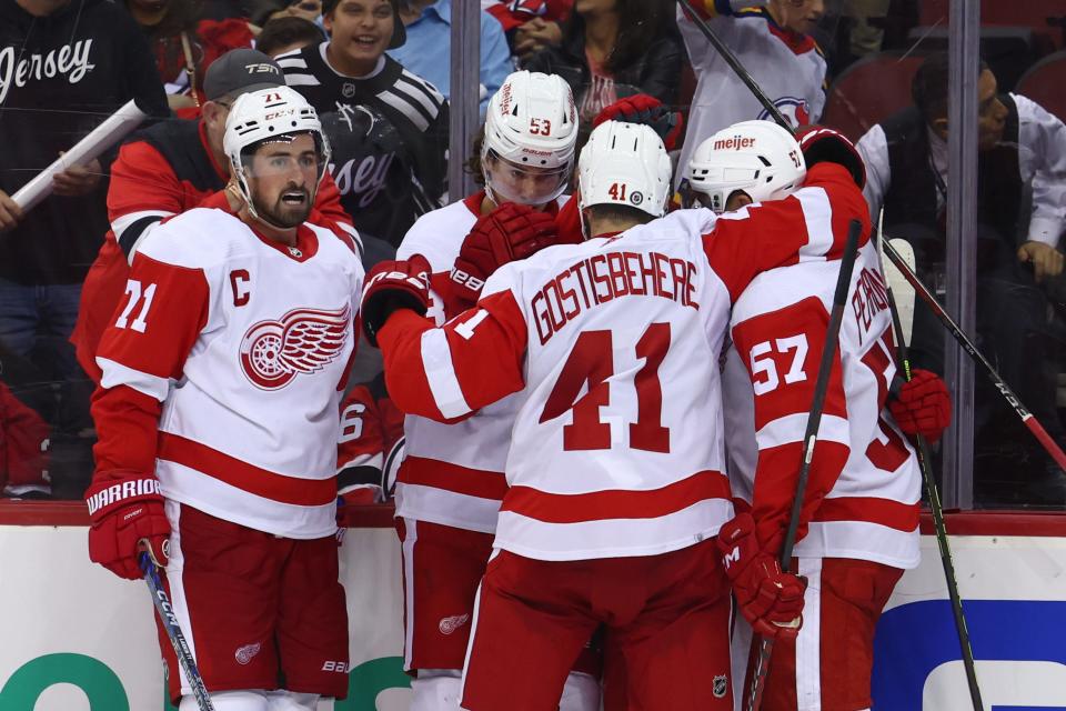 The Detroit Red Wings celebrate a goal by Detroit Red Wings right wing Alex DeBrincat (93) against the New Jersey Devils during the third period at Prudential Center in Newark, New Jersey, on Thursday, Oct. 12, 2023.