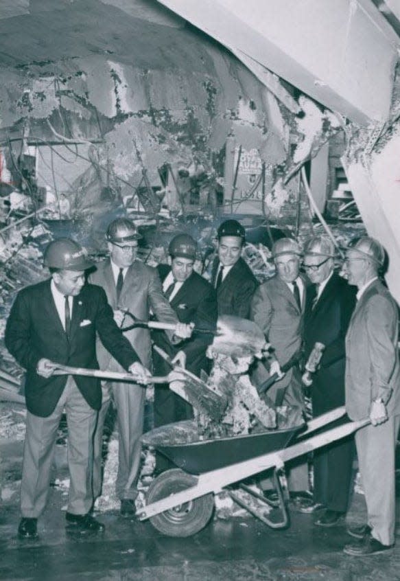 Officials clear ground in 1965 at a demolished building to make way for a new library at 55 S. Main St. in downtown Akron. Pictured are Raymond Brown, Walter deBruin, Louis Miletti, Gordon Canute, Mayor Edward O. Erickson, C. Blake McDowell and R. Russell Munn.