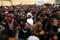 Displaced Iraqi men who just fled their homes sit at a screening center as Iraqi forces battle with Islamic State militants, in western Mosul, Iraq March 2, 2017. REUTERS/Zohra Bensemra