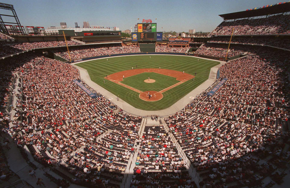 FILE - This is a March 29, 1997 file photo of baseball fans as they fill the stands as the Atlanta Braves play an exhibition game against the New York Yankess, the first baseball game ever to be played in the new Turner Field in Atlanta. Converting the Olympic Stadium to a baseball park helped to keep the Braves in downtown Atlanta. For athletes and spectators at Sochi, it’s time to pack up. But for the host cities, the real challenge begins with the end of the Olympics. How do they continue to use the expensive stadiums after the party’s over? What happens to the athletes’ villages? What is the legacy of the games? After the 1996 games, the Olympics stadium was converted into Turner Field, the baseball stadium that’s been home to the Atlanta Braves for the past several years (AP Photo/Ric Feld, File)