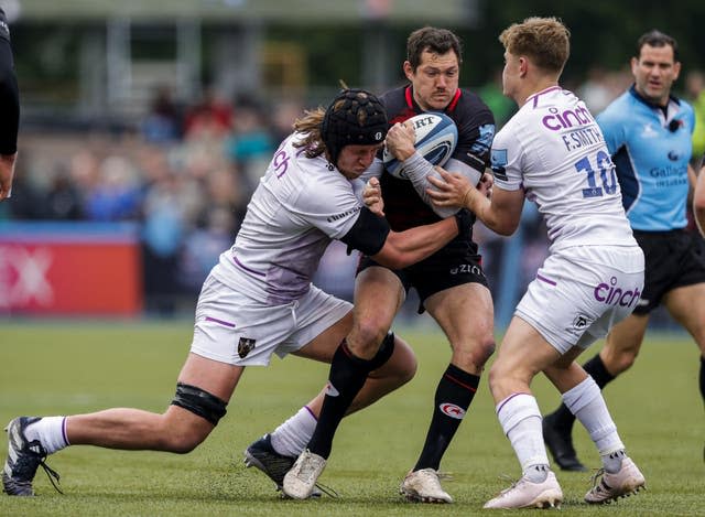 Alex Goode, centre, takes on the Northampton defence