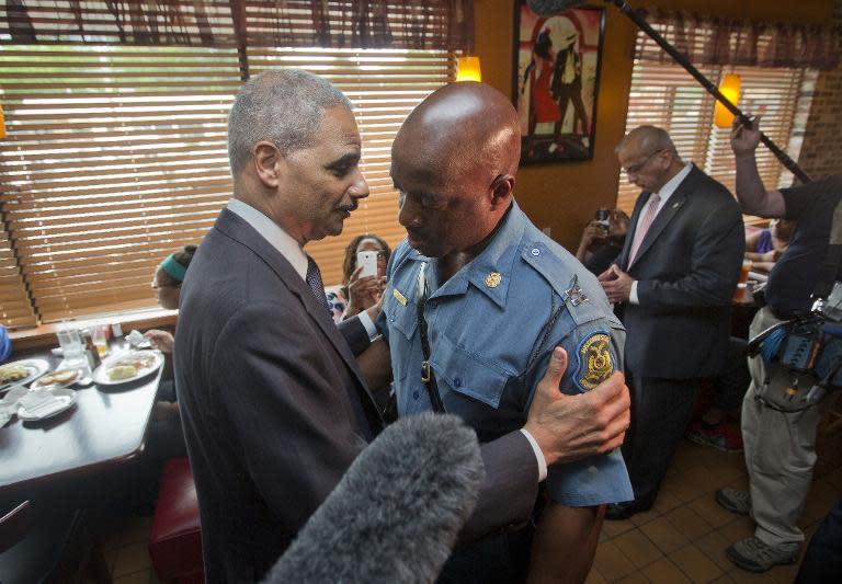 US Attorney General Eric Holder (L) greets Capt. Ron Johnson of the Missouri State Highway Patrol, at Drake's Place Restaurant in Florissant , Missouri, August 20, 2014