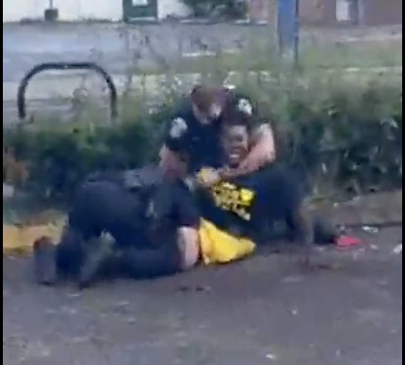 This screenshot of a bystander's cellphone video captures the forceful arrest of Jordan D. Ely Sr., 31, who was taken into custody on a felony drug charge and misdemeanors for resisting arrest and obstruction of justice.