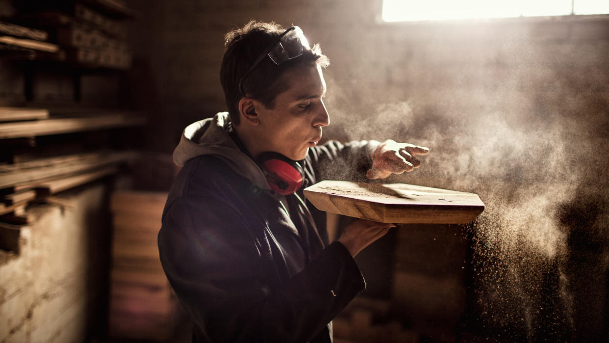 Close up of a carpenter looking at the finished product.