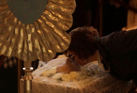 Maria do Ceu, wife of Brazilian singer Joao Gilberto, kisses his face during his wake in Rio de Janeiro's Municipal Theater