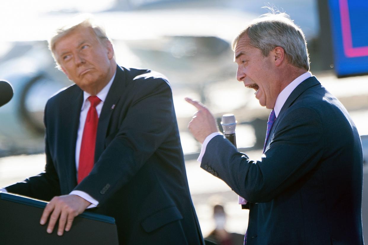 US President Donald Trump listens as Nigel Farage (R) speaks during a Make America Great Again rally at Phoenix Goodyear Airport October 28, 2020, in Goodyear, Arizona. (Photo by Brendan Smialowski / AFP) (Photo by BRENDAN SMIALOWSKI/AFP via Getty Images)