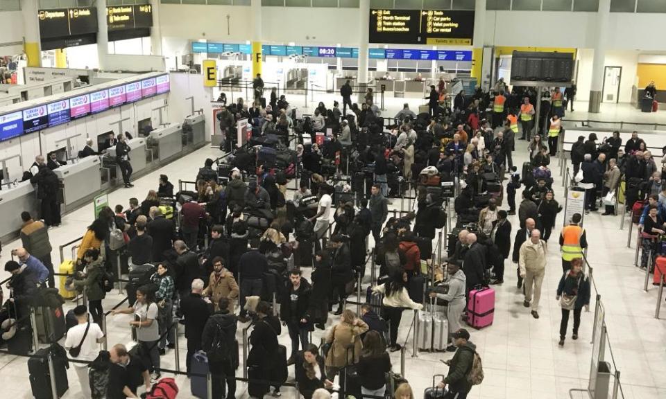 Passengers wait to check in at Gatwick in December as the airport tackles another drone crisis