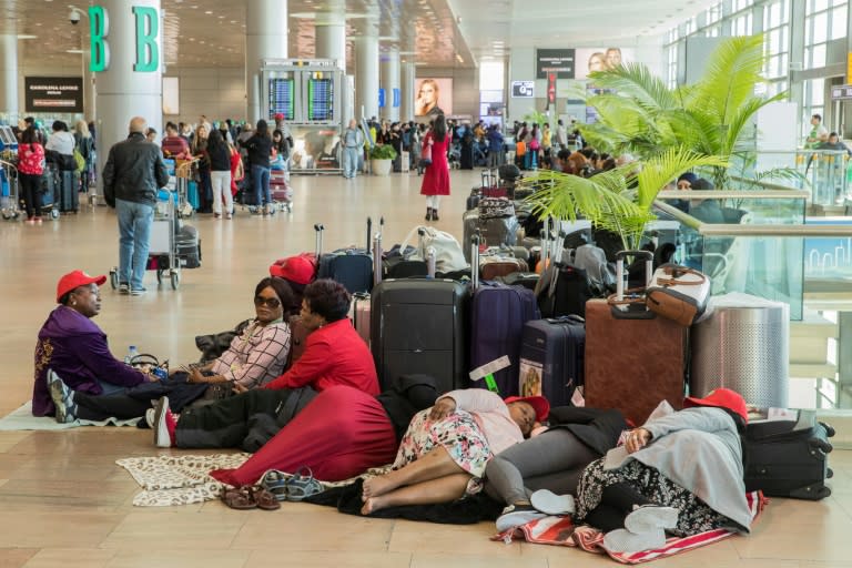 Travellers wait during a strike over cuts at pharmaceutical giant Teva at Israel's Ben Gurion Airport on December 17, 2017