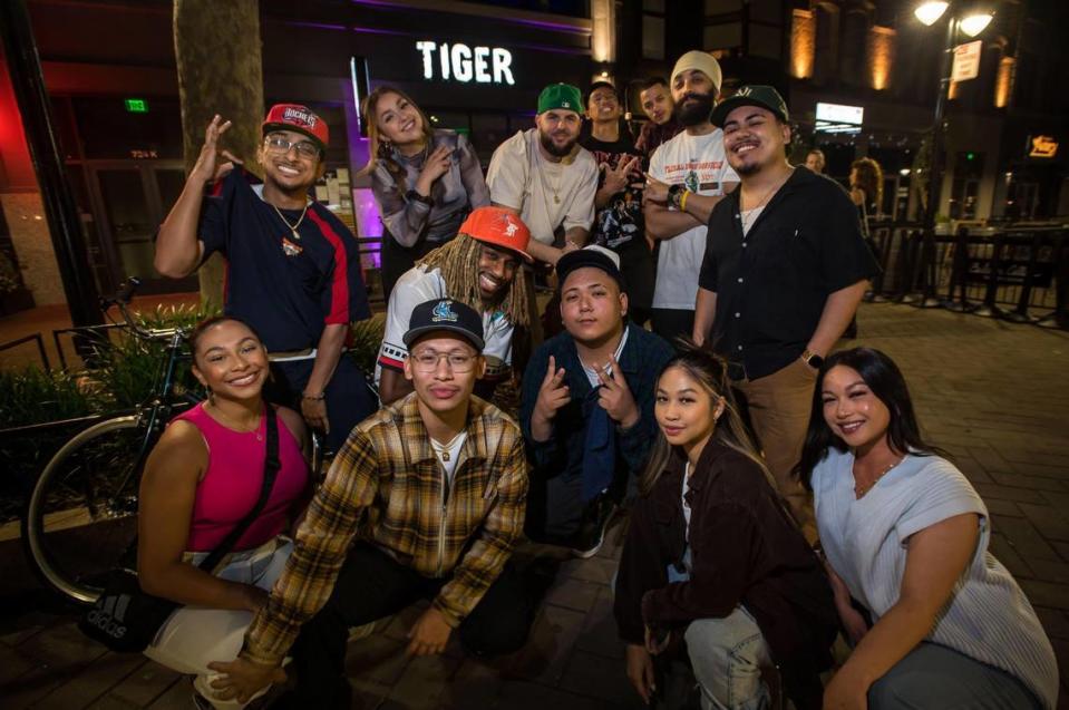 Members of Night Walkers dance and creative collective, pictured along with Tiger Restaurant & Lounge’s Robbie Metcalf and DJ Shino Smoke, host “Intrusion” featuring dance battles and showcases at Tiger on Thursday nights. The group are photographed in front of the venue June 8 in downtown Sacramento.