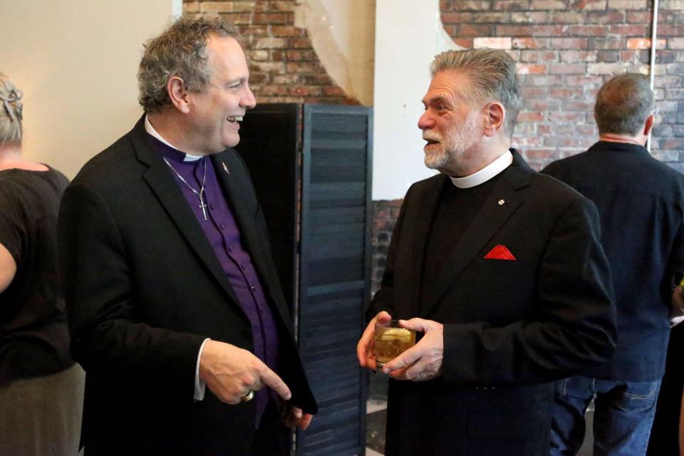 Rt. Rev. Frank Sullivan Logue, Bishop of Georgia, talks with Rev. William Willoughby III during a retirement party for Rev. Willoughby on Wednesday April 26, 2023 at Soho South. Rev Willoughby is retiring as Rector of the Collegiate Church of St. Paul the Apostle.  