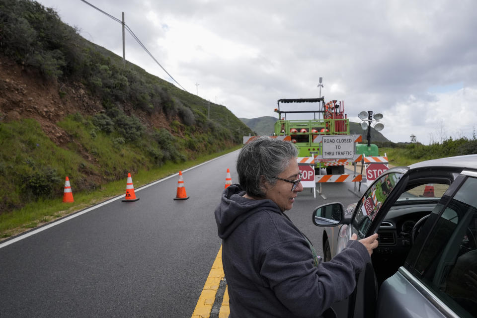 A woman gets back in her car after stoping at a road closure on Highway 1 near Big Sur, Calif., Thursday, April 4, 2024. The closure was caused by a break in the southbound lane of Highway 1 at Rocky Creek Bridge. (AP Photo/Godofredo A. Vásquez)
