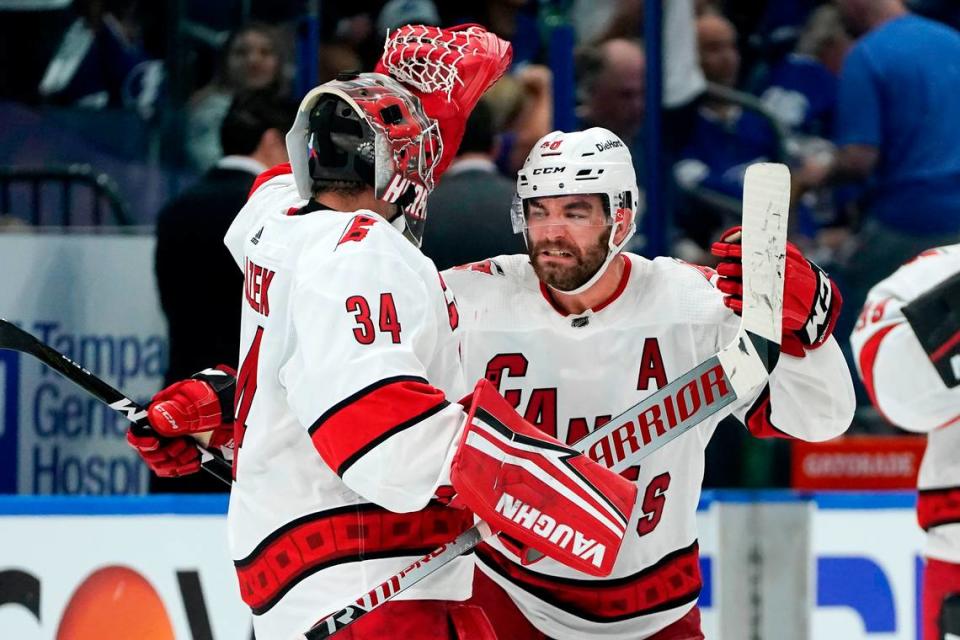 Carolina Hurricanes left wing Jordan Martinook (48) celebrates with goaltender Petr Mrazek (34) after the Hurricanes defeated the Tampa Bay Lightning during overtime in Game 3 of an NHL hockey Stanley Cup second-round playoff series Thursday, June 3, 2021, in Tampa.