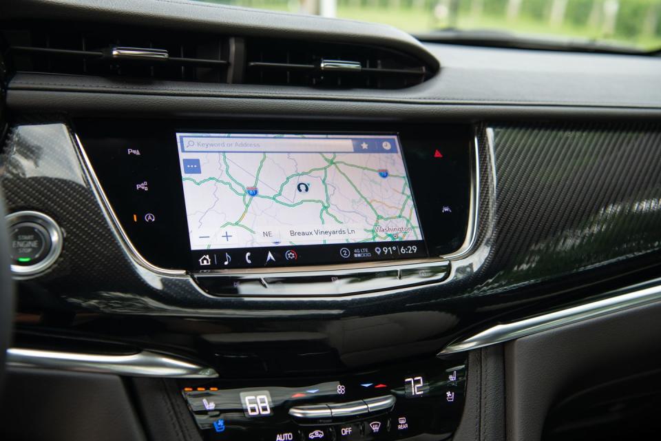 <p>The Cue infotainment system is standard in the Cadillac XT6. It's now easier to use thanks to the addition of a rotary control knob just ahead of the shifter.</p>