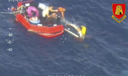 Migrants climb aboard a life raft deployed by an Armed Forces of Malta aircraft some 60 nautical miles south of the Italian island of Lampedusa October 11, 2013, in this picture released by the Armed Forces of Malta. REUTERS/Armed Forces Malta Press Office/Handout via Reuters