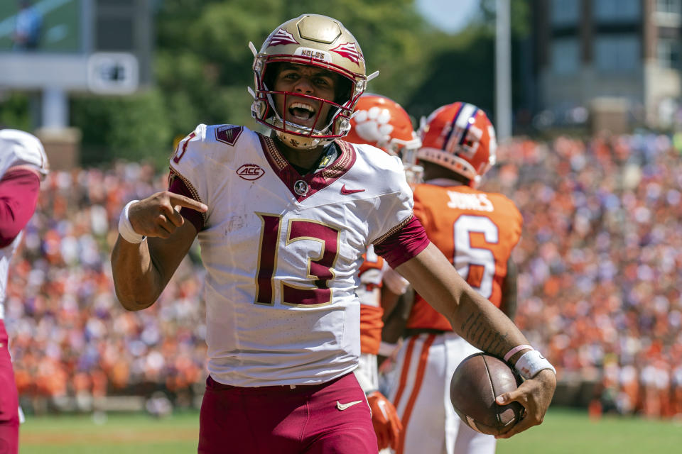 Florida State quarterback Jordan Travis (13) reacts after scoring a touchdown during the first half of an NCAA college football game against Clemson, Saturday, Sept. 23, 2023, in Clemson, S.C. (AP Photo/Jacob Kupferman)