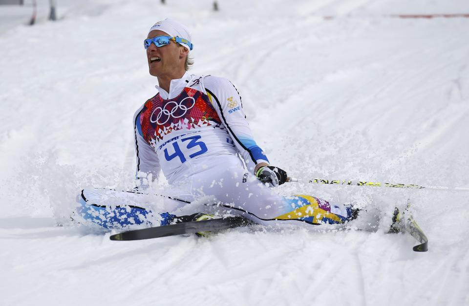 Sweden's Daniel Richardsson falls on the ground after crossing the finish line during the men's 15 km cross-country classic event at the Sochi 2014 Winter Olympic Games in Rosa Khutor February 14, 2014. REUTERS/Kai Pfaffenbach (RUSSIA - Tags: SPORT SKIING OLYMPICS)