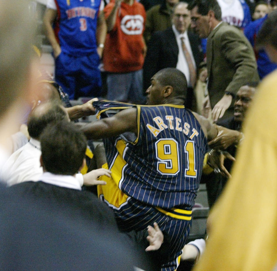 Indiana Pacers forward Ron Artest is grabbed by fans after he went into the seats during a a brawl with the Detroit Pistons with just 45.9 seconds left in the game on Nov. 19, 2004.  (AP Photo/Duane Burleson)