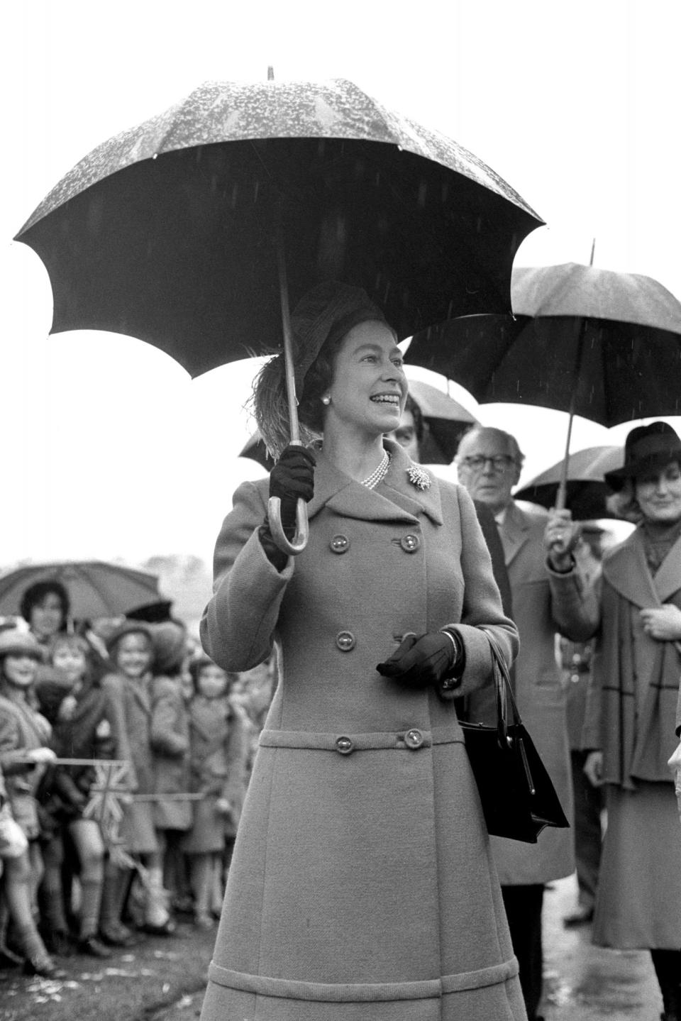 <p>On a rainy day The Queen visits the Royal Borough of Windsor and Maidenhead. (PA Archive) </p>