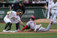 Los Angeles Angels' Andrew Velazquez, bottom, is tagged out by Oakland Athletics third baseman Jordan Diaz while trying to steal third base during the seventh inning of a baseball game in Oakland, Calif., Saturday, Sept. 2, 2023. Also pictured is umpire Chad Whitson, top left. (AP Photo/Jeff Chiu)