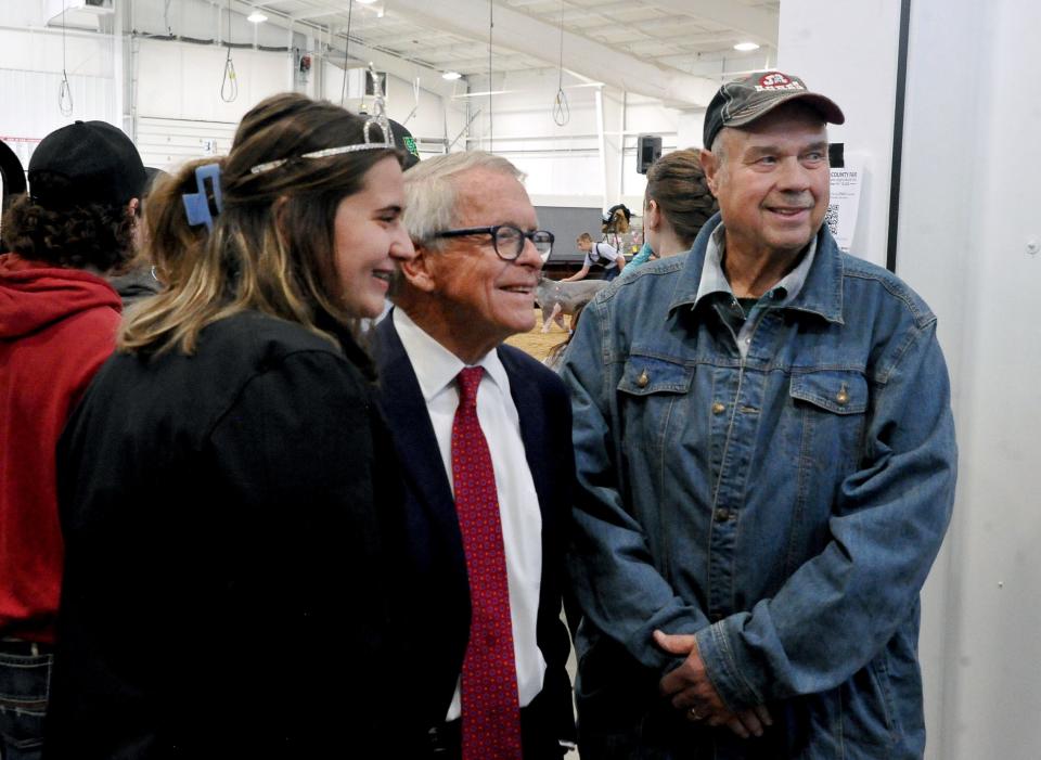 At the Wayne County Fair on Tuesday, Sept. 13, 2022, Gov. Mike DeWine poses for a photo with this year's fair queen, Morgan Vodika, and Ron Grosjean.