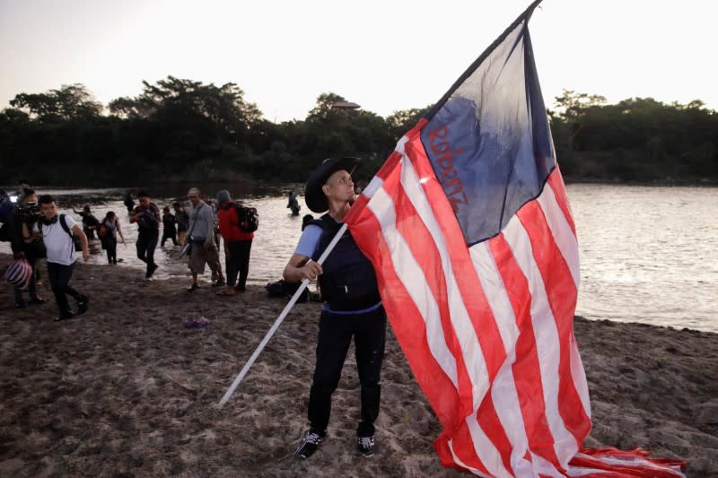 Migrants, mainly from Central America and marching in a caravan, walk after crossing the Suchiate river, on the outskirts of Ciudad Hidalgo