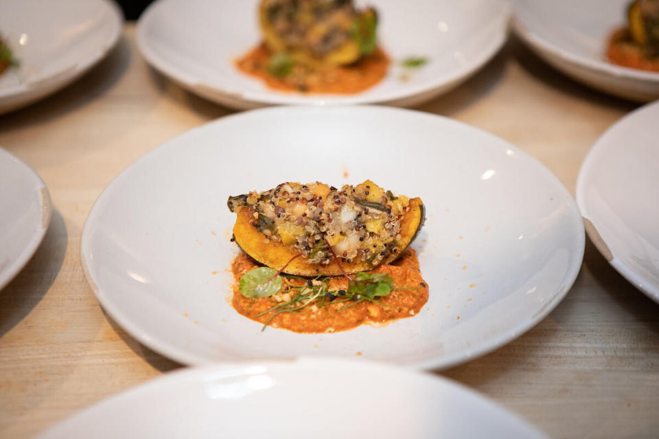 Roasted squash with collard greens, kuchela, creamed peas and preserved peach; romesco, and citrus-toasted bread crumbs. (Photo: Clay Williams)