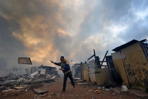 A resident tries to save his belongings from fire during an eviction at Capao Redondo favelo or shantytown, in Sao Paulo. Eduardo Jorge wants to curb urban sprawl and social segregation by revitalizing the city's rundown downtown area with vertical construction